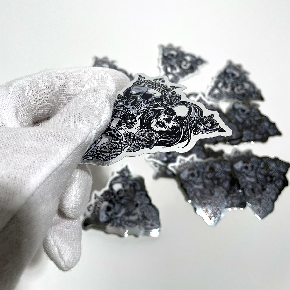 Close-up of a mirror chrome die-cut sticker