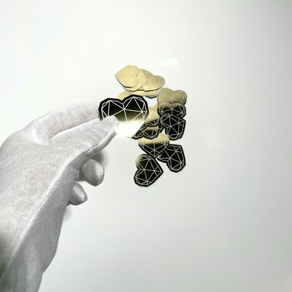 Gold mirror sticker held in hand