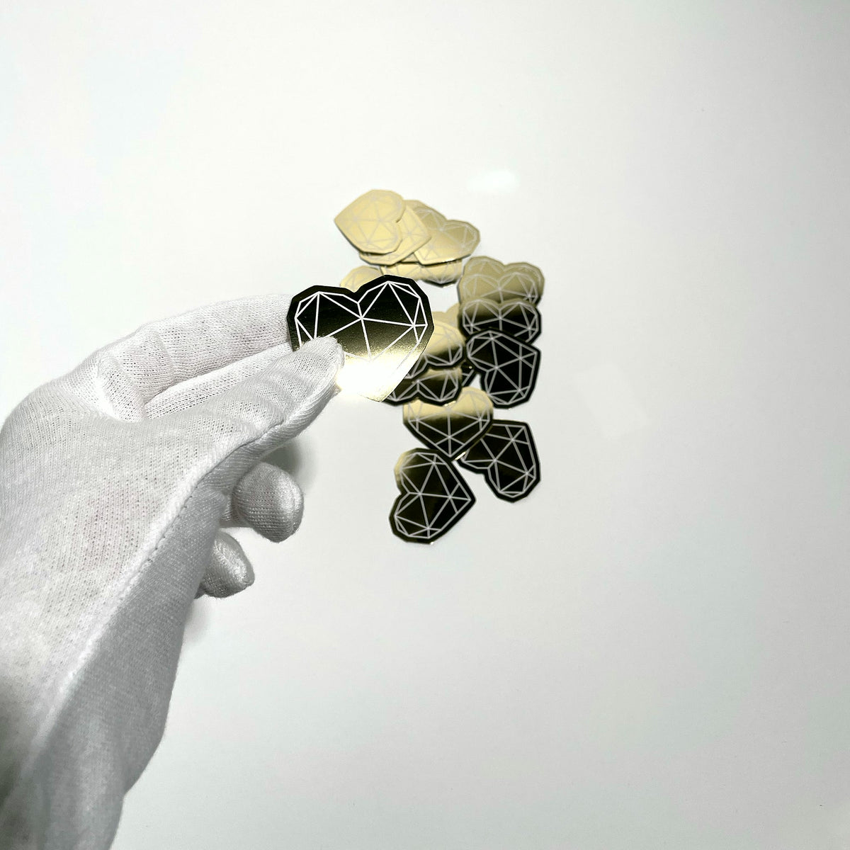 Gold mirror sticker held in hand