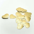 Gold mirror die-cut diamonds and hearts laid out flat