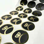 Gold on black round labels on the roll