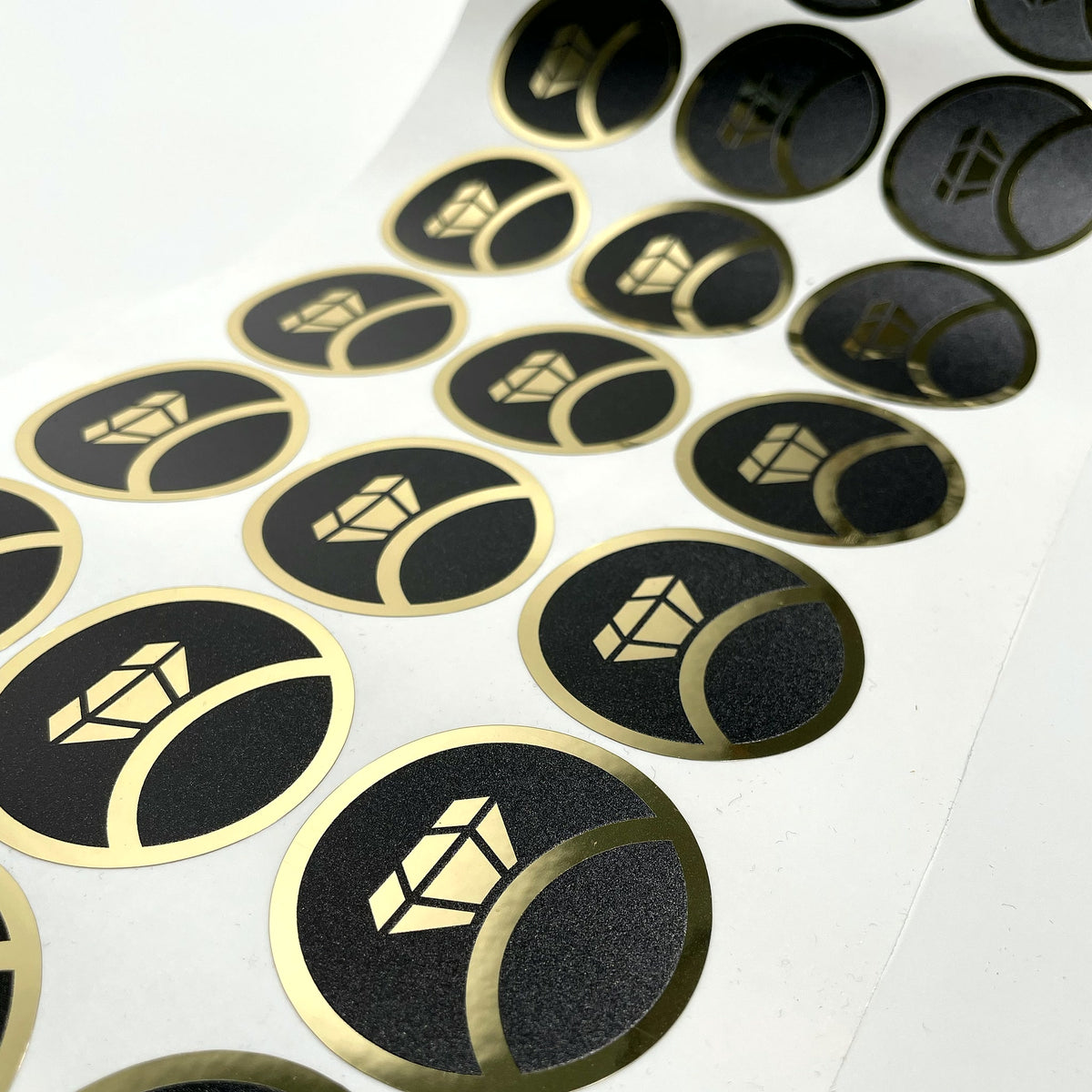 Gold on black round labels on the roll