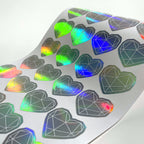 Holographic die-cut hearts on the backing sheet