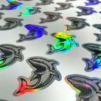 Holographic die-cut shark stickers on the sheet