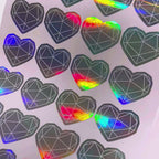 Holographic die-cut hearts changing colour as the sheet moves