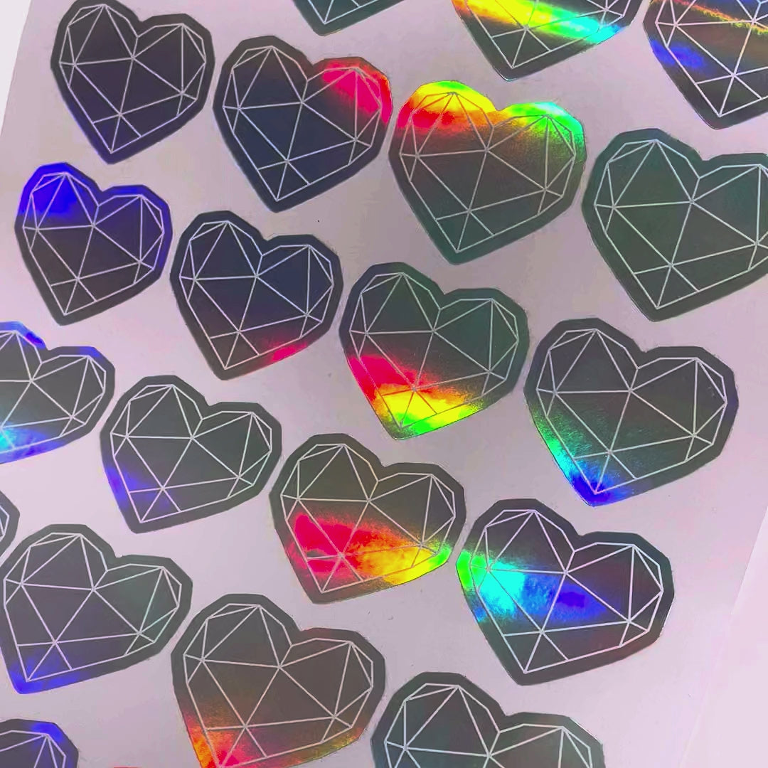 Holographic die-cut hearts changing colour as the sheet moves